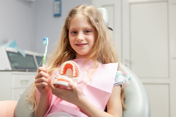 Should I Take My Child To A Kid Friendly Dentist In Freehold For White Spots On Teeth?